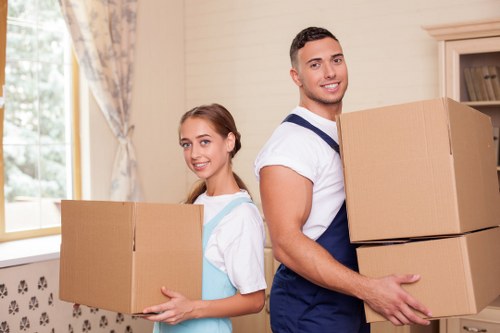 Movers handling fragile items with care during transport